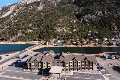 an aerial view of a resort in front of a mountain at Microtel Inn & Suites by Wyndham Georgetown Lake in Georgetown