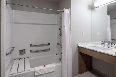 a bathroom with a shower and a sink at Microtel Inn & Suites by Wyndham Georgetown Lake in Georgetown