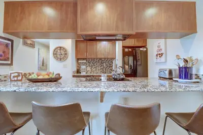 a kitchen with wooden cabinets and a counter top at 201C Mountain Side 1BR 1BA condo in Frisco