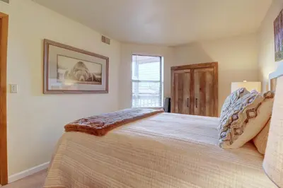 a bedroom with a bed and a picture on the wall at 201C Mountain Side 1BR 1BA condo in Frisco