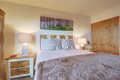 a bedroom with a large bed and two lamps at 201C Mountain Side 1BR 1BA condo in Frisco