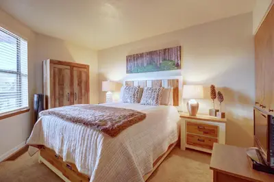 a bedroom with a large bed and a window at 201C Mountain Side 1BR 1BA condo in Frisco