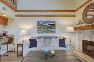 a living room with a couch and a fireplace at 201C Mountain Side 1BR 1BA condo in Frisco