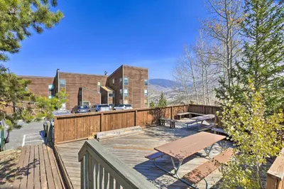 a wooden deck with a bench and a building at Ski, Shred and Tube Mtn-View Condo in Silverthrone! in Silverthorne