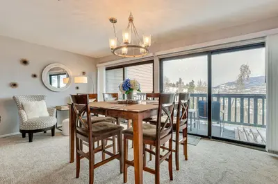 a dining room with a table and chairs and a large window at Ski, Shred and Tube Mtn-View Condo in Silverthrone! in Silverthorne