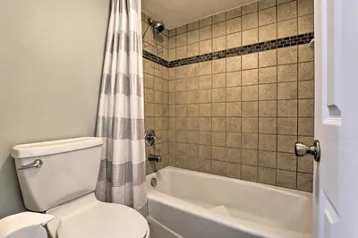 a bathroom with a toilet and a tub and a shower curtain at Ski, Shred and Tube Mtn-View Condo in Silverthrone! in Silverthorne