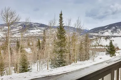 a snow covered yard with trees and mountains at Ski, Shred and Tube Mtn-View Condo in Silverthrone! in Silverthorne