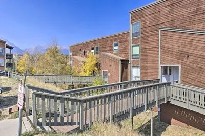 a house with a wooden ramp next to a building at Ski, Shred and Tube Mtn-View Condo in Silverthrone! in Silverthorne