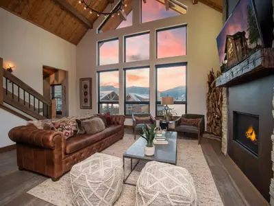 a living room with a couch and a fireplace at Relax in Luxury - Jacuzzi, Indoor/Outdoor Fireplace in Estes Park