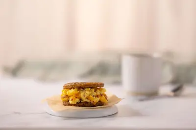 a breakfast sandwich on a plate on a counter at Drury Inn & Suites Denver Tech Center in Centennial