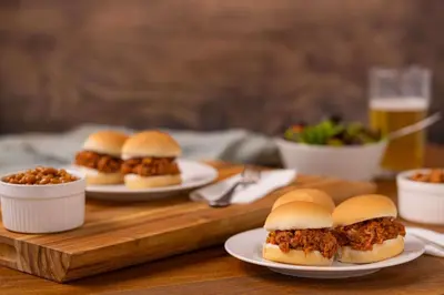 a group of sandwiches on plates on a wooden table at Drury Inn & Suites Denver Tech Center in Centennial