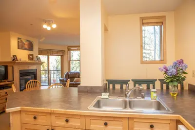 a kitchen with a sink and a living room at 8176 Silver Mill condo in Keystone