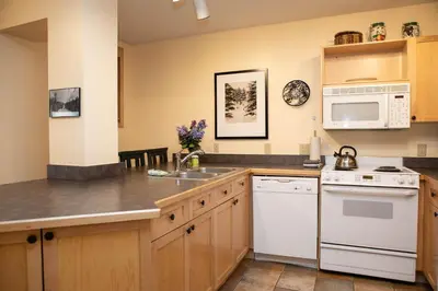 a kitchen with a sink and a microwave at 8176 Silver Mill condo in Keystone