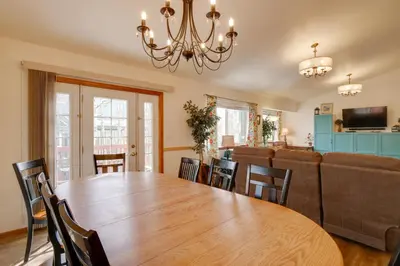 a dining room and living room with a wooden table and chairs at 8 Mi to Copper Mtn Dtwn Frisco Retreat with Deck! in Frisco