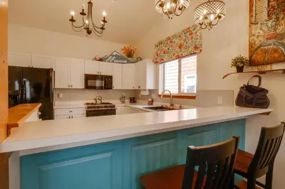 a kitchen with blue cabinets and a white counter top at 8 Mi to Copper Mtn Dtwn Frisco Retreat with Deck! in Frisco