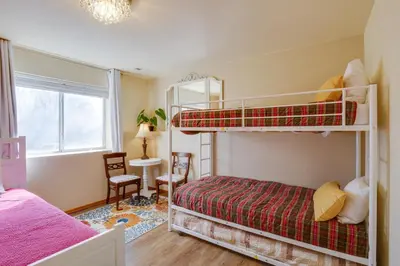 a bedroom with two bunk beds and a desk at 8 Mi to Copper Mtn Dtwn Frisco Retreat with Deck! in Frisco