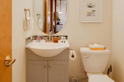 a bathroom with a sink and a toilet and a mirror at 8 Mi to Copper Mtn Dtwn Frisco Retreat with Deck! in Frisco