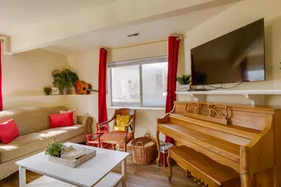 a living room with a piano and a couch at 8 Mi to Copper Mtn Dtwn Frisco Retreat with Deck! in Frisco