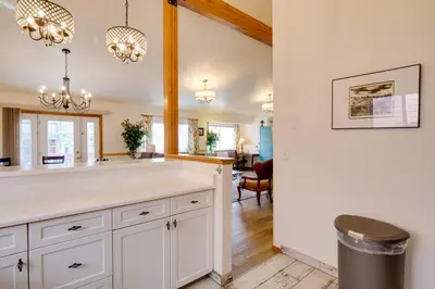 a kitchen with white cabinets and a dining room at 8 Mi to Copper Mtn Dtwn Frisco Retreat with Deck! in Frisco