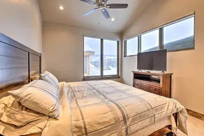a bedroom with a bed and a flat screen tv at Relax Fireside Silverthorne Home 11 Mi to Skiing! in Silverthorne