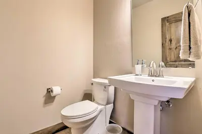 a bathroom with a white toilet and a sink at Relax Fireside Silverthorne Home 11 Mi to Skiing! in Silverthorne
