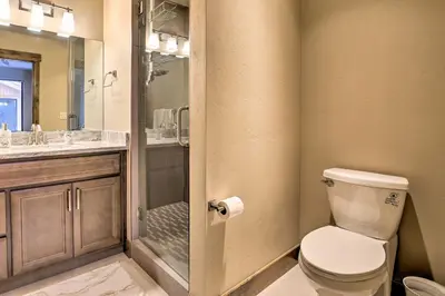 a bathroom with a toilet and a glass shower at Relax Fireside Silverthorne Home 11 Mi to Skiing! in Silverthorne