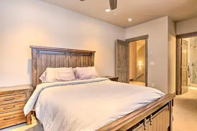 a bedroom with a large bed with a wooden headboard at Relax Fireside Silverthorne Home 11 Mi to Skiing! in Silverthorne