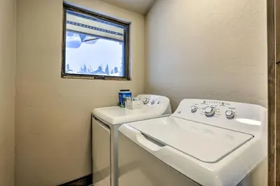 a bathroom with a sink and a washing machine at Relax Fireside Silverthorne Home 11 Mi to Skiing! in Silverthorne