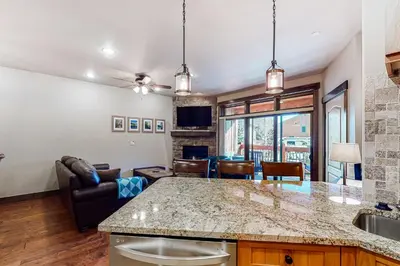 a kitchen and living room with a large counter top at Frisco Frolic in Frisco