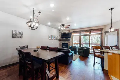 a living room with a table and a couch at Frisco Frolic in Frisco