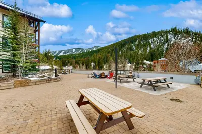 a group of picnic benches on a brick patio at Founders Pointe Condo in Winter Park