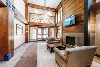a living room with a fireplace and a tv at Founders Pointe Condo in Winter Park