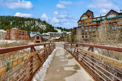 a bridge over a road in a mountain town at Founders Pointe Condo in Winter Park