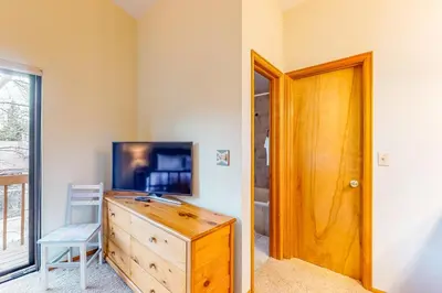 a room with a wooden dresser and a wooden door at Dawn's Cabin in Frisco