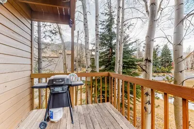 a grill sitting on the deck of a cabin at Dawn's Cabin in Frisco