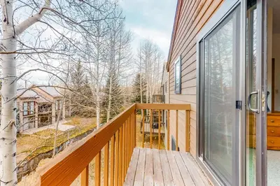 a balcony with a sliding glass door on a house at Dawn's Cabin in Frisco