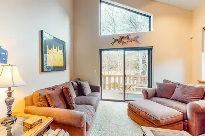 a living room with two couches and a table at Dawn's Cabin in Frisco