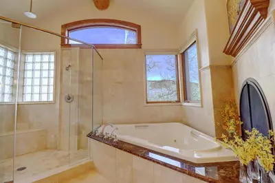 a bathroom with a tub and a glass shower at Good Elevations on Two Cabins Drive home in Silverthorne