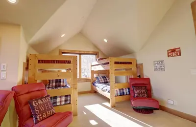 a attic room with two bunk beds and a couch at Good Elevations on Two Cabins Drive home in Silverthorne