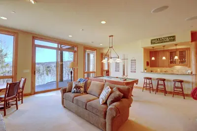 a living room with a couch and a pool table at Good Elevations on Two Cabins Drive home in Silverthorne