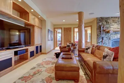 a living room with a couch and a tv at Good Elevations on Two Cabins Drive home in Silverthorne
