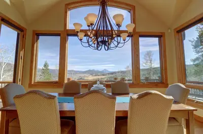 a dining room with a table and chairs and a chandelier at Good Elevations on Two Cabins Drive home in Silverthorne