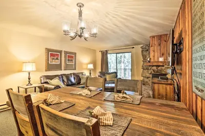 a dining room with a table and a couch at Cozy Ski Chalet Less Than 3 Mi to Winter Park Resort! in Winter Park