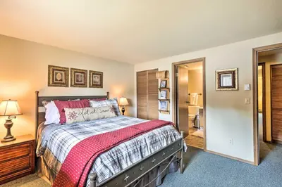 a bedroom with a bed with a red blanket at Cozy Ski Chalet Less Than 3 Mi to Winter Park Resort! in Winter Park