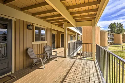 a porch with two chairs and a table on it at Cozy Ski Chalet Less Than 3 Mi to Winter Park Resort! in Winter Park