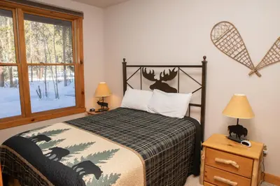 a bedroom with a bed and a window at 8750 Trappers Crossing condo in Keystone