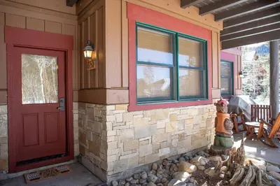 a house with a red door and a window at 8750 Trappers Crossing condo in Keystone