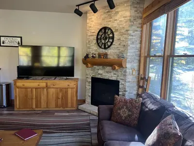 a living room with a television and a fireplace at 8750 Trappers Crossing condo in Keystone