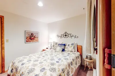 a bedroom with a bed and a chandelier at Marina Place 336 in Dillon