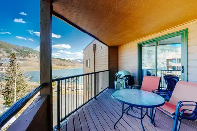a balcony with a table and chairs and a view of the water at Marina Place 336 in Dillon